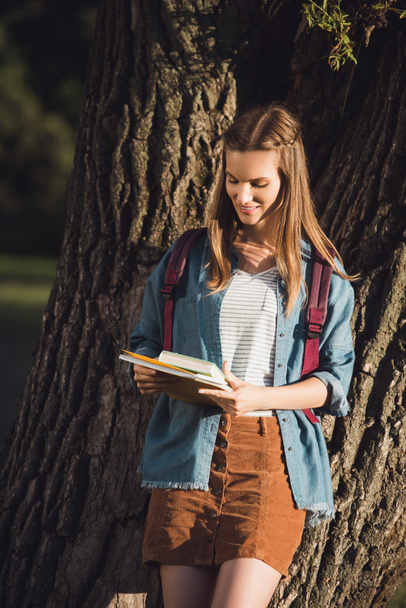 young girl with books in park - Foto, Imagen