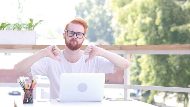 Thumbs Down by Man Sitting in Outdoor Office, Red Hairs - Photo, Image