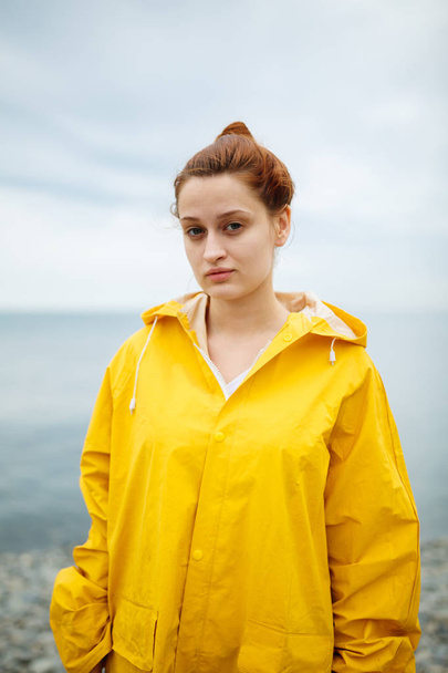Girl wearing yellow raincoat - Foto, imagen