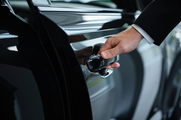 Close up of a male hand closing a car door - Fotografie, Obrázek