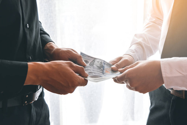 Two business man dealing with handing money - Photo, Image