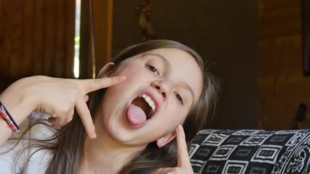 beautiful young teen girl makes grimaces face - Footage, Video