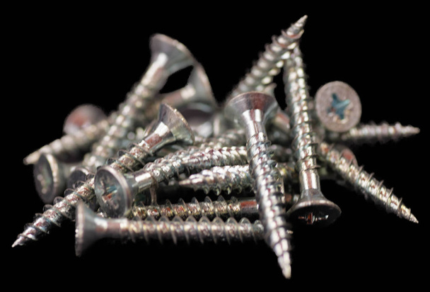 A Pile of Screws Isolated on a Black Back Ground - Photo, Image