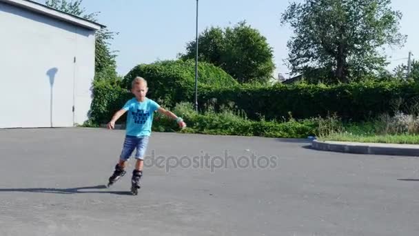 Happy children, two boys of seven, rollerblading, a hot summer day. Slow motion - Footage, Video