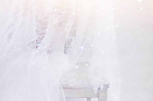 Beautiful white wedding dress and veil on chair - Foto, immagini