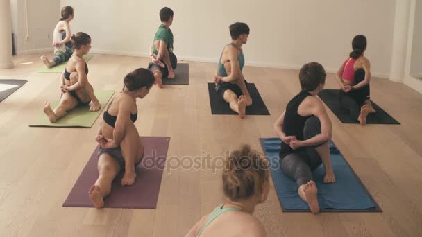 Group of people doing yoga asanas in studio - Footage, Video