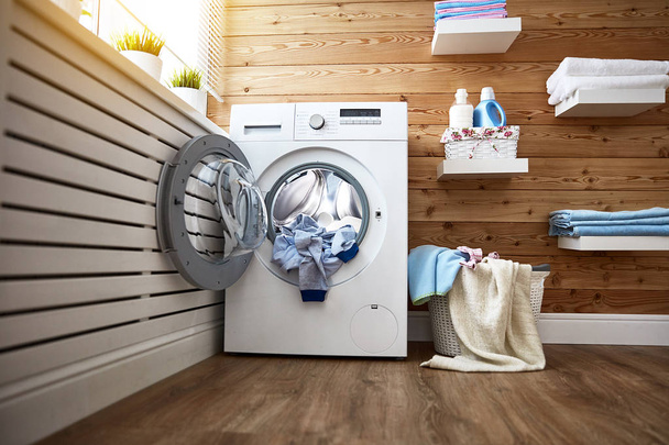 Interior of real laundry room with  washing machine at window at - Photo, Image