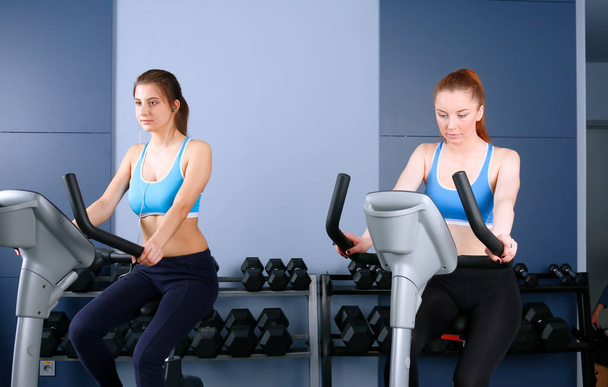 Group of people at the gym exercising on cross trainers. people at the gym - Photo, Image
