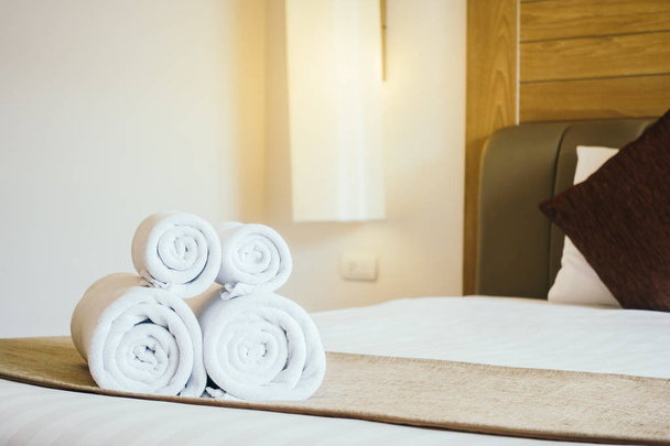 Witte badhanddoek op bed - Foto, afbeelding