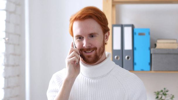 Talking on Phone, Man with Red Hairs Attending Phone Call - Photo, Image