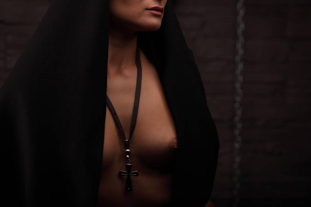 Naked nun, studio concept shooting. half dresssed model pretends nun - Φωτογραφία, εικόνα
