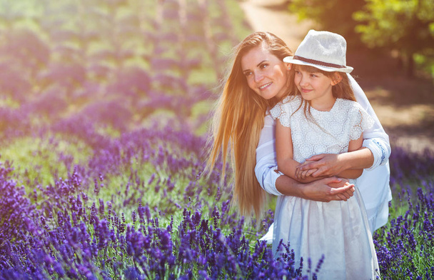 Family portrait in lavender field, mother and daughter having fun - Photo, image