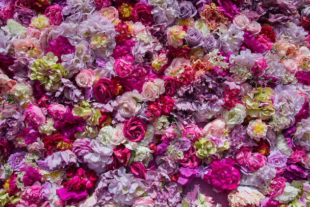 Carpet of multi-colored artificial flowers. Backgrounds and textures - Photo, Image