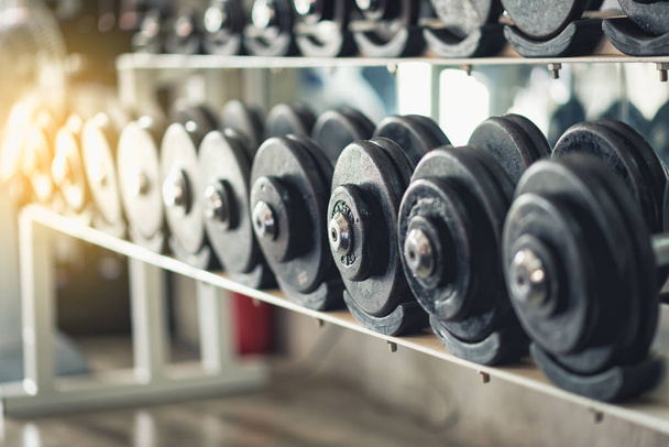 Rows of dumbbells in the gym, vintage color - Фото, изображение