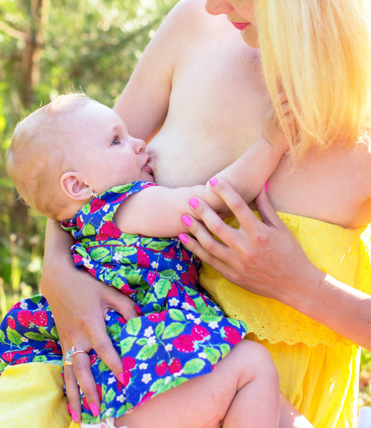 Happy mother breast-feeding a baby - Photo, Image