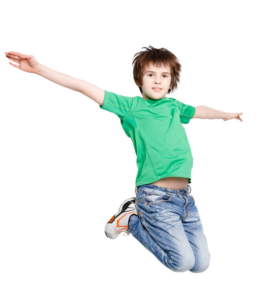 Happy laughing boy jumping on white isolated background - Foto, imagen