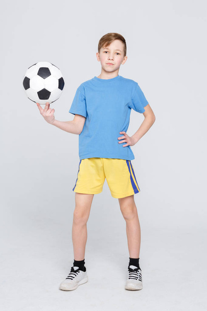 Boy in casual with soccer ball at white studio background - Foto, Imagen