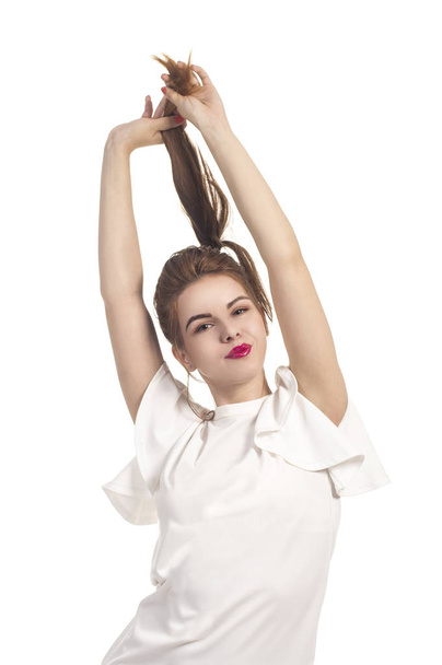 Girl in summer dress plays with hair. - Zdjęcie, obraz