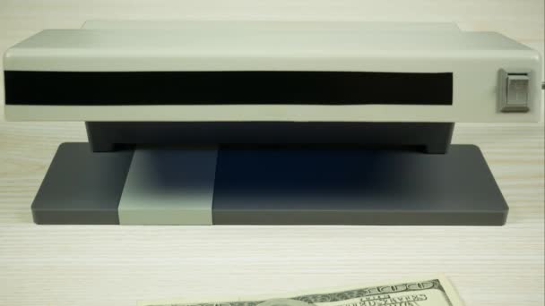 A hundred-dollar bill becomes one-dollar under the ultraviolet light. Stop motion - Footage, Video