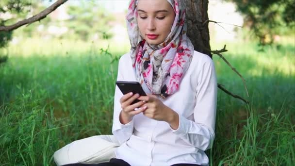 Mladé a moderní Muslimská žena mluvila komunikuje prostřednictvím mobilního telefonu s přáteli - Záběry, video