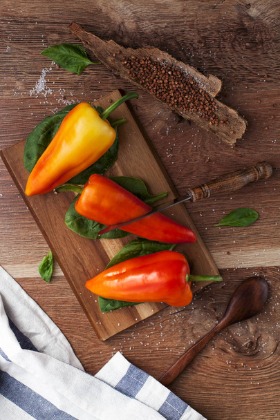 Fresh pepper and herbs on a wooden table - Photo, Image