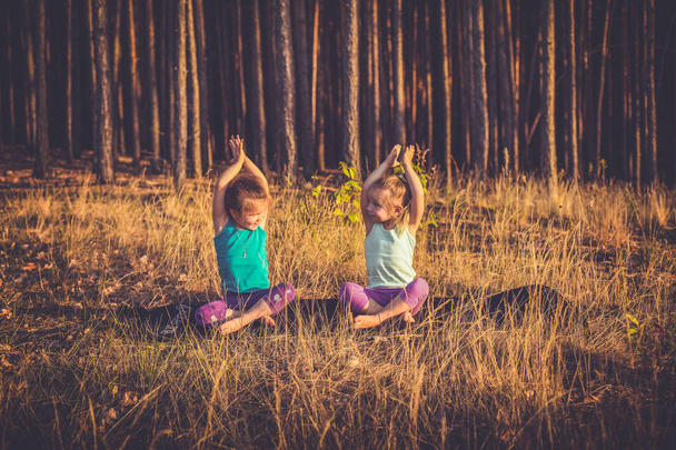little girls practicing yoga - 写真・画像