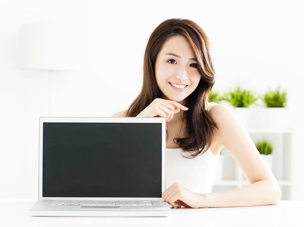 smiling young woman showing laptop screen  - Fotografie, Obrázek