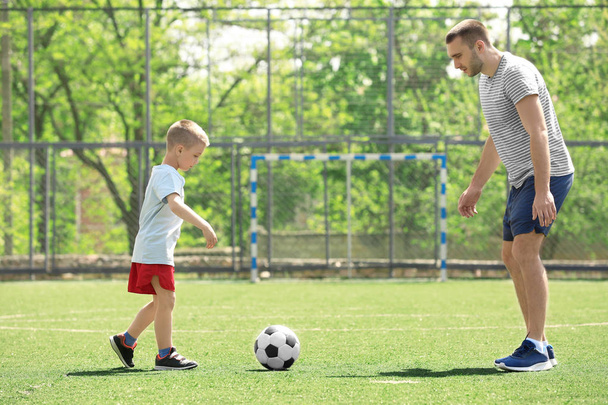 Father and son playing football   - Φωτογραφία, εικόνα
