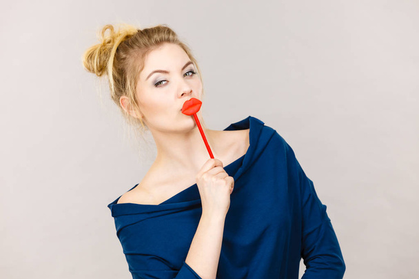 Funny woman holding big red lips on stick - Фото, зображення