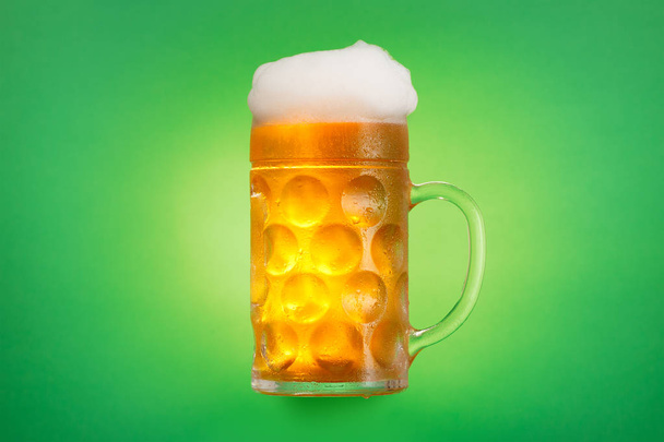 Mug of beer glass on green background. - Фото, зображення