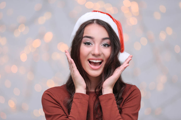 Pretty emotional lady in Christmas hat   - Zdjęcie, obraz