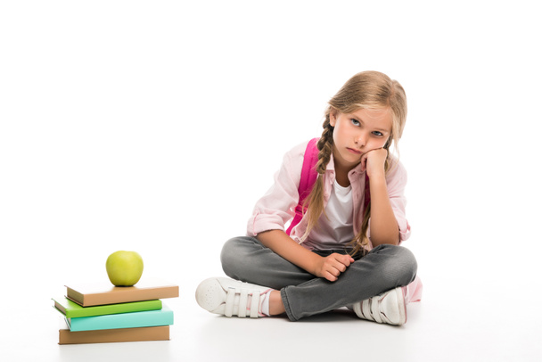 bored schoolgirl with books with apple - Foto, Bild