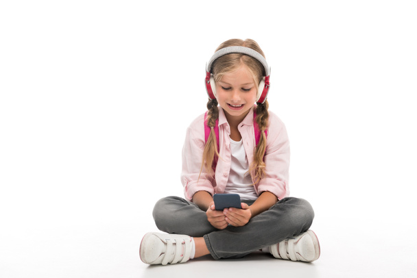 schoolgirl with smartphone and headphones - Photo, Image