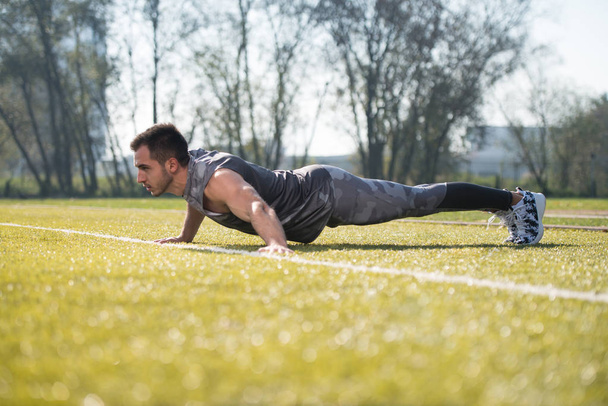 Young Man Doing Push-up Exercise Outside - Foto, Bild
