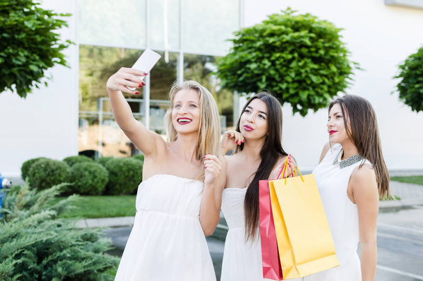three happy woman in shopping - Фото, изображение