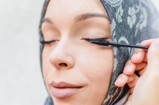 arab female combing eyelashes extension - Фото, изображение
