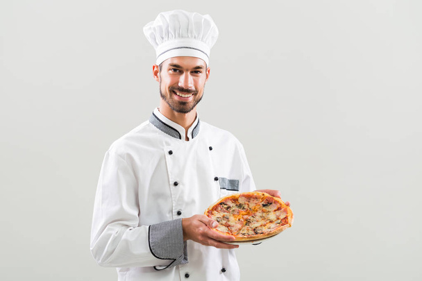Chef holding pizza  - Фото, изображение