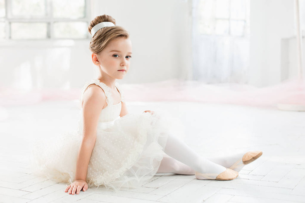 The little balerina in white tutu in class at the ballet school - Фото, зображення