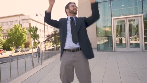 Handsome businessman celebrating and doing a crazy dance to the camera - Filmmaterial, Video
