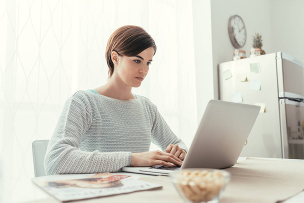 Young woman working with laptop - Φωτογραφία, εικόνα