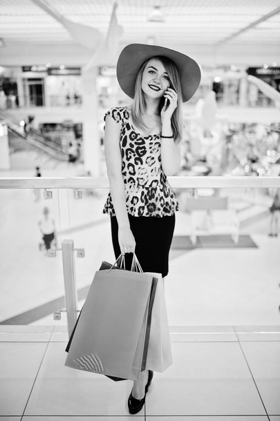 Portrait of a woman in leopard blouse, black skirt walking in sh - Fotografie, Obrázek