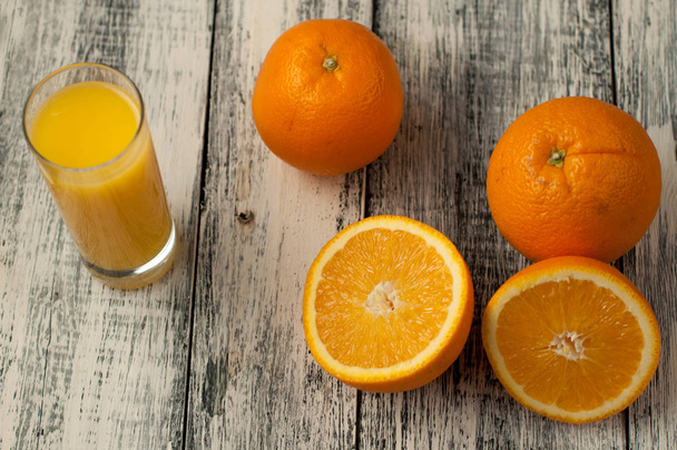 Orange fruit cut and orange juice on wooden table background, - 写真・画像