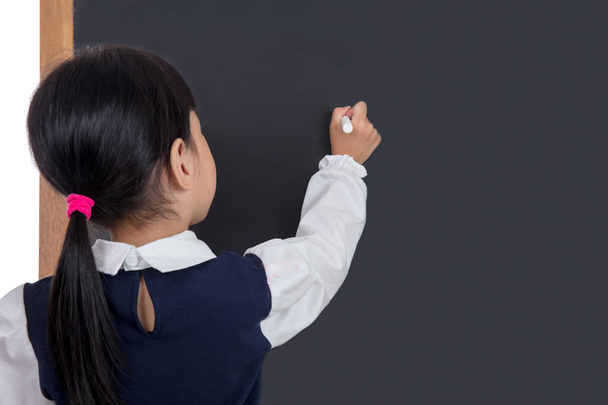 Asian Chinese little girl writing on blackboard - Zdjęcie, obraz