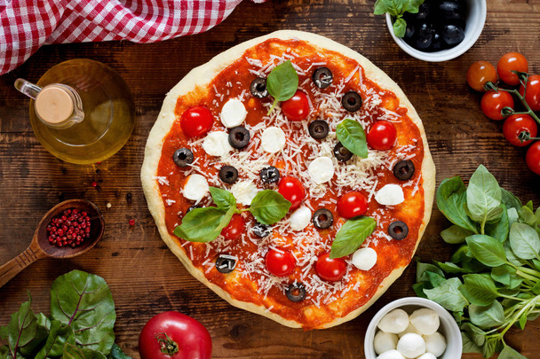 Homemade italian pizza on wooden table top view - Photo, Image