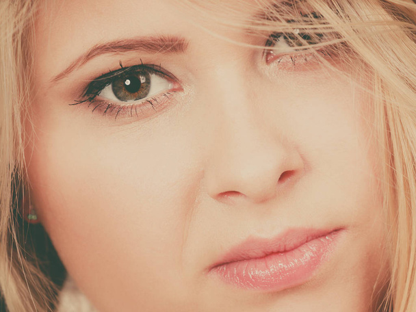 Closeup portrait of attractive blonde woman face - 写真・画像