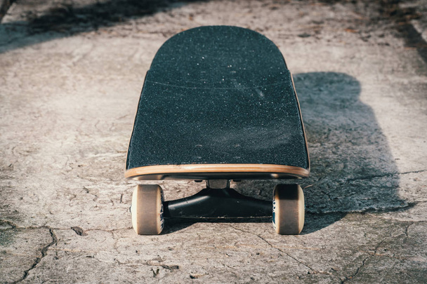 Skateboard on concrete floor in skatepark - Фото, изображение