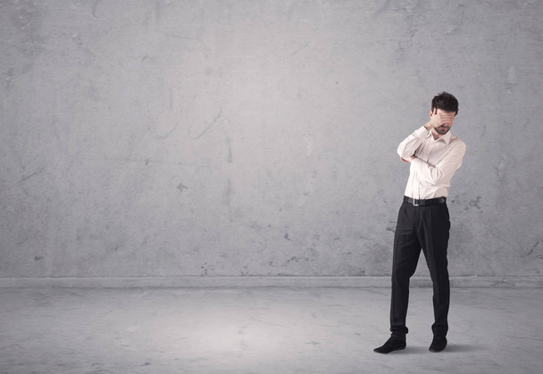 Young businessman standing confused - 写真・画像