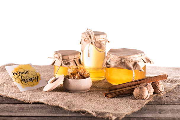 honey in glass jars and card - Φωτογραφία, εικόνα