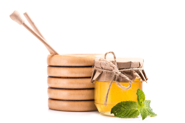 honey in glass jar and wooden barrel - Photo, Image