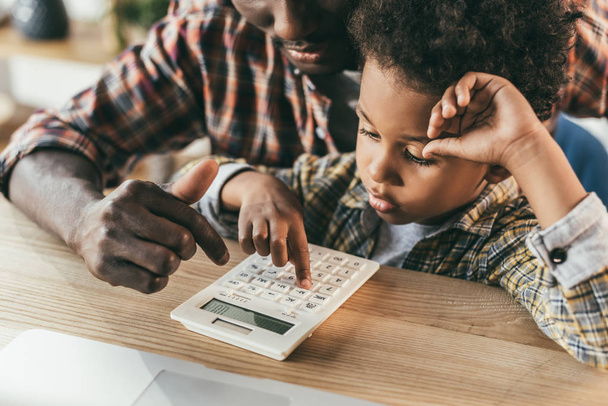 father and son with calculator - Photo, Image